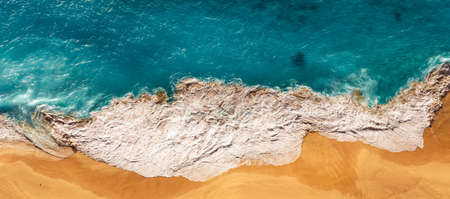 Aerial view of blue ocean waves in Kelingking beach, Nusa penida Island in Bali, Indonesia. Beautiful sandy beach with blue sea. Lonely sandy beach with beautiful waves. Seascape background. Panoramaの写真素材