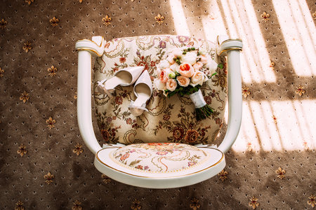 Bride's bouquet. Bride wedding morning. Delicate beige shoes and a wedding bouquet. Bride's accessories. Wedding accessories. Wedding details. Top view.の写真素材