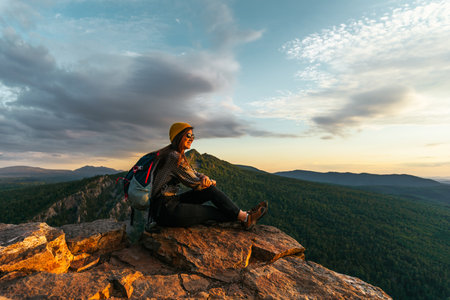 A woman is traveling in Bashkiria, Russia. Mountain tourism in Russia. Walking tour of the mountains of Bashkiria, Aigir. A trip to the mountains with a backpack. Copy spaceの写真素材