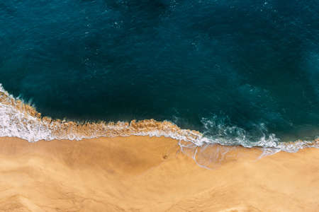 Lonely beach view from above. Sandy beach with blue sea. Beautiful seascape, beach on the island of Nusa Penida, Indonesia. The sea coast with yellow sand and blue ocean. Clean coast. Copy spaceの写真素材