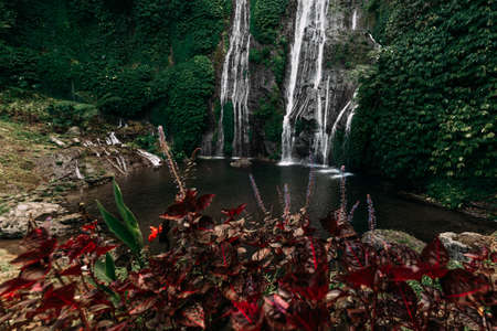 Big waterfall in Indonesia. Waterfalls Of Bali. Landscapes Of Asia. Waterfall among the green mountains. Copy spaceの写真素材