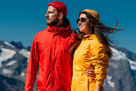 Portrait of travelers against the background of mountains. Portrait of travelers in tourist clothes...