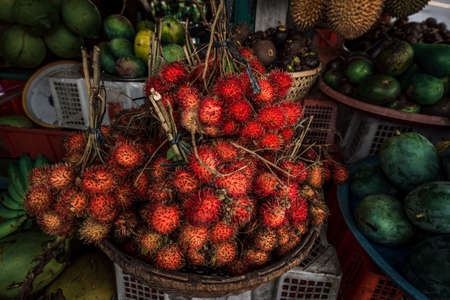 Fruit shop in Thailand. Fruit market in Indonesia Bali island. Street bazaar in Asia. Sale of fresh fruits and vegetables at the market in Thailand. A small grocery store on the street of Bali islandの写真素材