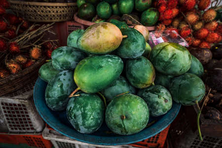 Fruit shop in Thailand. Fruit market in Indonesia Bali island. Street bazaar in Asia. Sale of fresh fruits and vegetables at the market in Thailand. A small grocery store on the street of Bali islandの写真素材