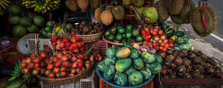 Fruit shop in Thailand. Fruit market in Indonesia Bali island. Street bazaar in Asia. Sale of fresh fruits and vegetables at the market in Thailand. A small grocery store on the street of Bali islandの写真素材
