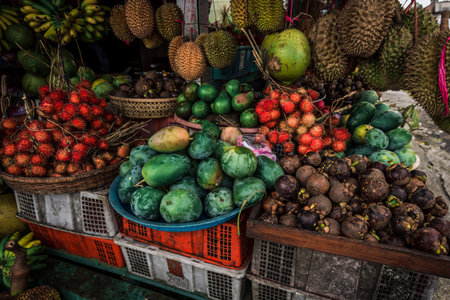 Fruit shop in Thailand. Fruit market in Indonesia Bali island. Street bazaar in Asia. Sale of fresh fruits and vegetables at the market in Thailand. A small grocery store on the street of Bali islandの写真素材