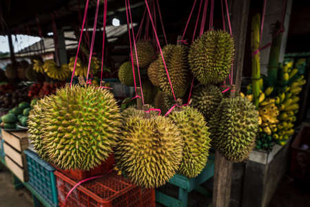 Fruit shop in Thailand. Fruit market in Indonesia Bali island. Street bazaar in Asia. Sale of fresh fruits and vegetables at the market in Thailand. A small grocery store on the street of Bali islandの写真素材