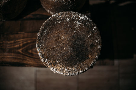 A chamber for maturation and aging of cheese circles in a private cheese factory. Cheese maturation cellar. Private elite cheese factory. Close-upの写真素材