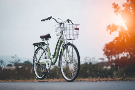 a bicycle parking on the road, women bike with nate landscape background and grass, copy space, Vintage color gradingの写真素材