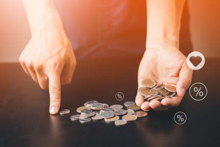 A man with coin money saving and investment growth business, success, computer graphic orange light,...