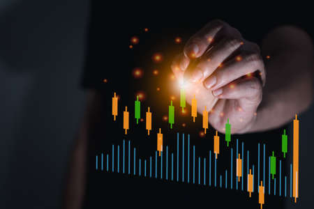 The business man with cryptocurrency trading graph, new economic concept computer graphic light, businesss and finance, focus on handの写真素材
