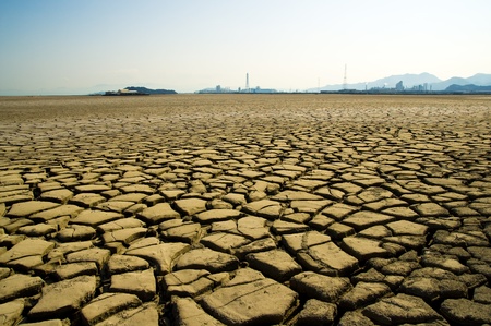 factory and cracked clay ground into the dryの写真素材