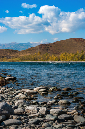 A view of the river and the mountains with rocky coastの写真素材