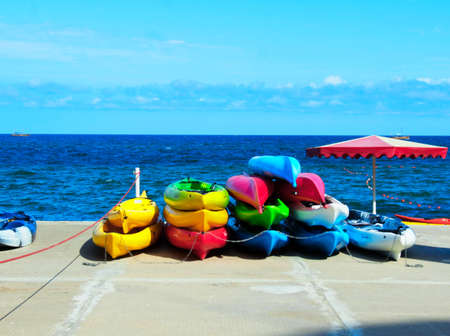 Bright and colored canoes lie on the shoreの写真素材