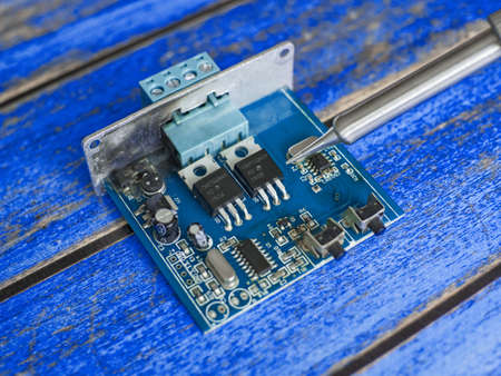 Damaged electronic board during repair with a soldering ironの写真素材