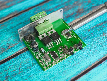 Damaged electronic board during repair with a soldering ironの写真素材