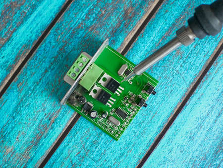 Damaged electronic board during repair with a soldering ironの写真素材