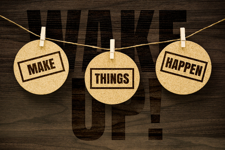 Wake Up. Make Things Happen. Life inspirational quotes text on hanging on round cork board with wood background.の写真素材