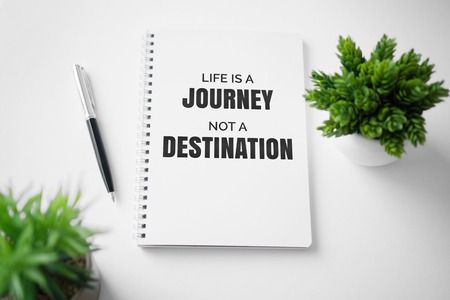 Motivational and inspirational quote. Wisdom quote about life. Notebook with potted plant.の写真素材