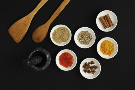 Asian spices, herbs and cooking ingredients on black background.の写真素材
