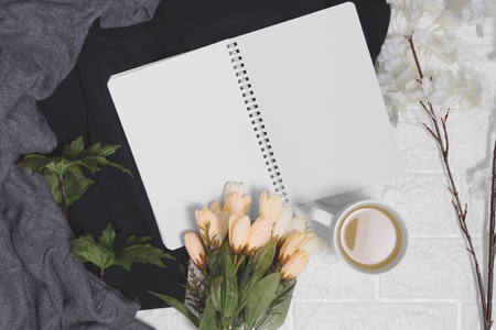 Open spiral notebook with blank pages on wood background. Rustic nostalgia with copy space.の写真素材