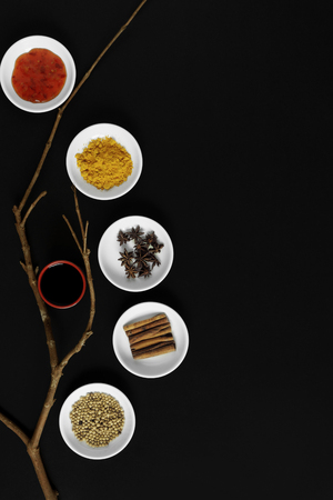 Asian spices, herbs and cooking ingredients on black background.の写真素材