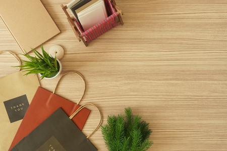 Paper bags with notebook, greeting cards and potted plant. Copy space.の写真素材