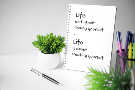 Motivational and inspirational quote. Wisdom quote about life. Notebook with potted plant.の写真素材