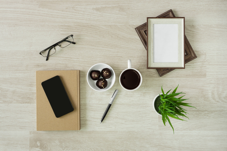 Notebooks with hot coffee and cookies on wood background. Rustic home office.の写真素材