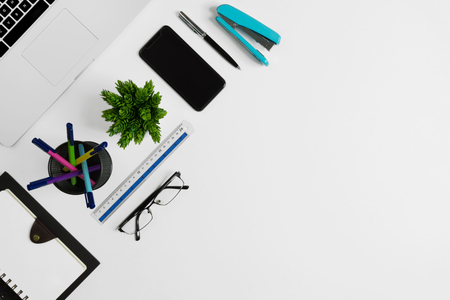 Office supplies on white office desk. Minimal simplicity flat lay with copy space.の写真素材