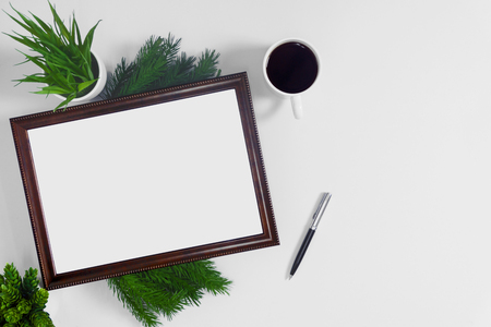 Picture frame with coffee and potted plant on white background.の写真素材