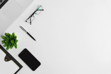 Office supplies on white office desk. Minimal simplicity flat lay with copy space.の写真素材
