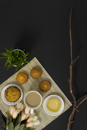 Coffee and cakes on black background. Breakfast meal flat lay.の写真素材