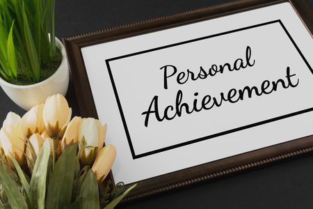 Personal Achievement on wood frame with flower and potted plant.の写真素材