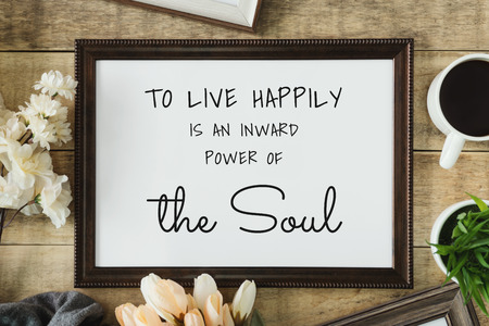 Wood frame with wisdom quote on rustic old wood background.の写真素材