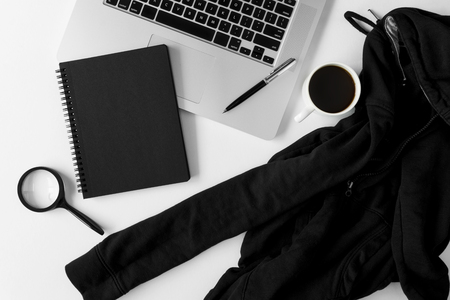 Notebook with copy space, sweater and laptop on white office table.の写真素材