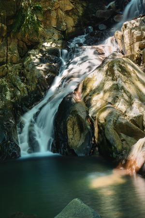 Small waterfall painted with the sun light at Kionsom Park.の写真素材