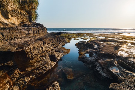 Rocky beach at Tanah Lot beach on sunset, Bali Indonesia.の写真素材