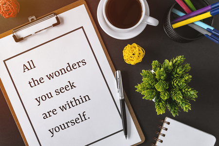 Inspirational and motivation life quote on clipboard with paper - All the wonders you seek are within yourself.の写真素材