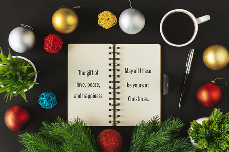 Notepad with season's greetings wish and ornament balls decoration. Merry Christmas and holiday concepts.の写真素材