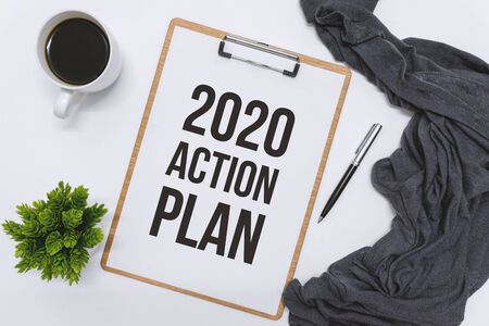 Overhead view of clipboard on white desk. 2020 Action Plan.の写真素材