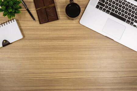 Overhead View of Laptop and Notebook on Wooden Work Deskの写真素材