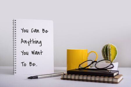 Spiral Notebook With Inspirational and Motivational Wisdom Quote on White Desk.の素材 [FY310132281260]