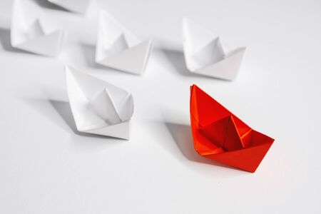Business and Leadership. Unique Paper Boat Leading The Rest By Example.の写真素材