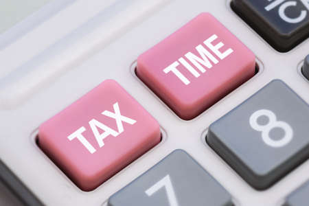 Close Up of Tax Time Words on Calculator Buttonsの写真素材