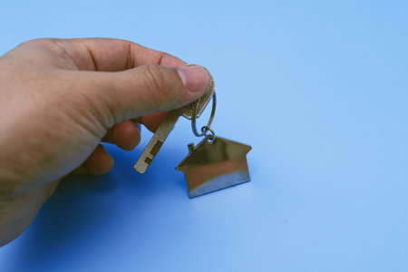 Hand Holding House Key. New Property and Home Ownership Concept.の写真素材
