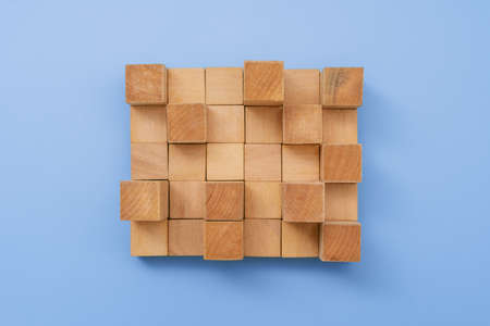 Arrangement of Wooden Building Blocks on Blue Background.の写真素材