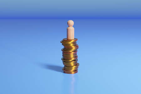 Wooden peg doll on stack of coins. Financial success concept.の写真素材