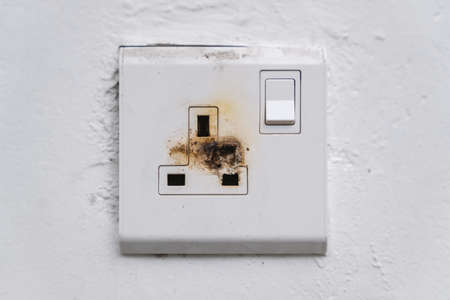 Broken and Damaged Burnt 3 Pin Wall Socketの写真素材