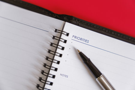 "Daily Planning with Personal Planner" - A personal planner and pen for daily planning on a red background.の写真素材